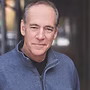 The Freeman Studio A middle-aged man with short gray hair wearing a gray zip-up sweater stands outdoors, looking at the camera with a neutral expression. New York & Toronto Acting Studio